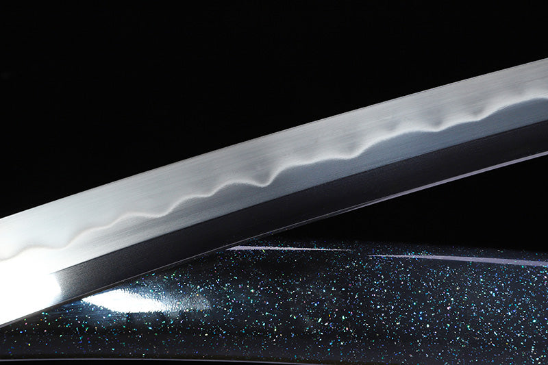 Green handle hand forged katana blade close-up - razor sharp steel edge and hamon