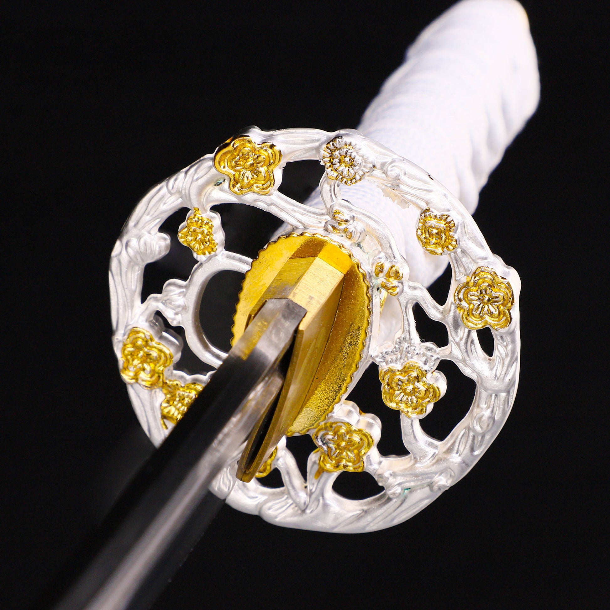 White handle floral tanto tsuba close-up - floral motif hand guard and habaki detail