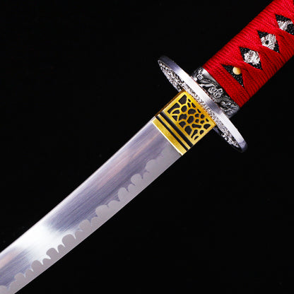 Red handle blood splatter tanto blade close-up - razor sharp steel edge and hamon
