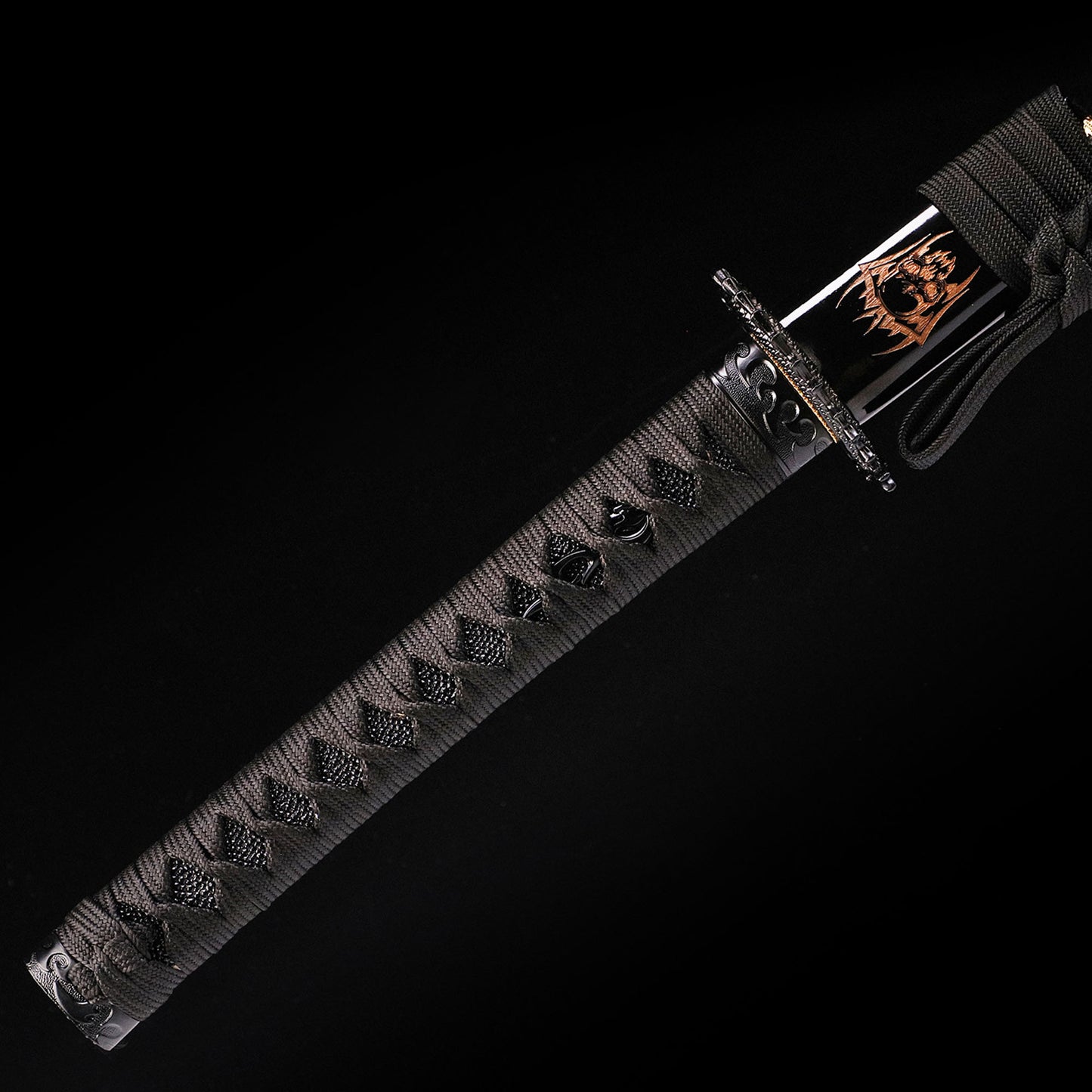 Black Dragon katana handle close-up - black tsuka wrap with dragon design