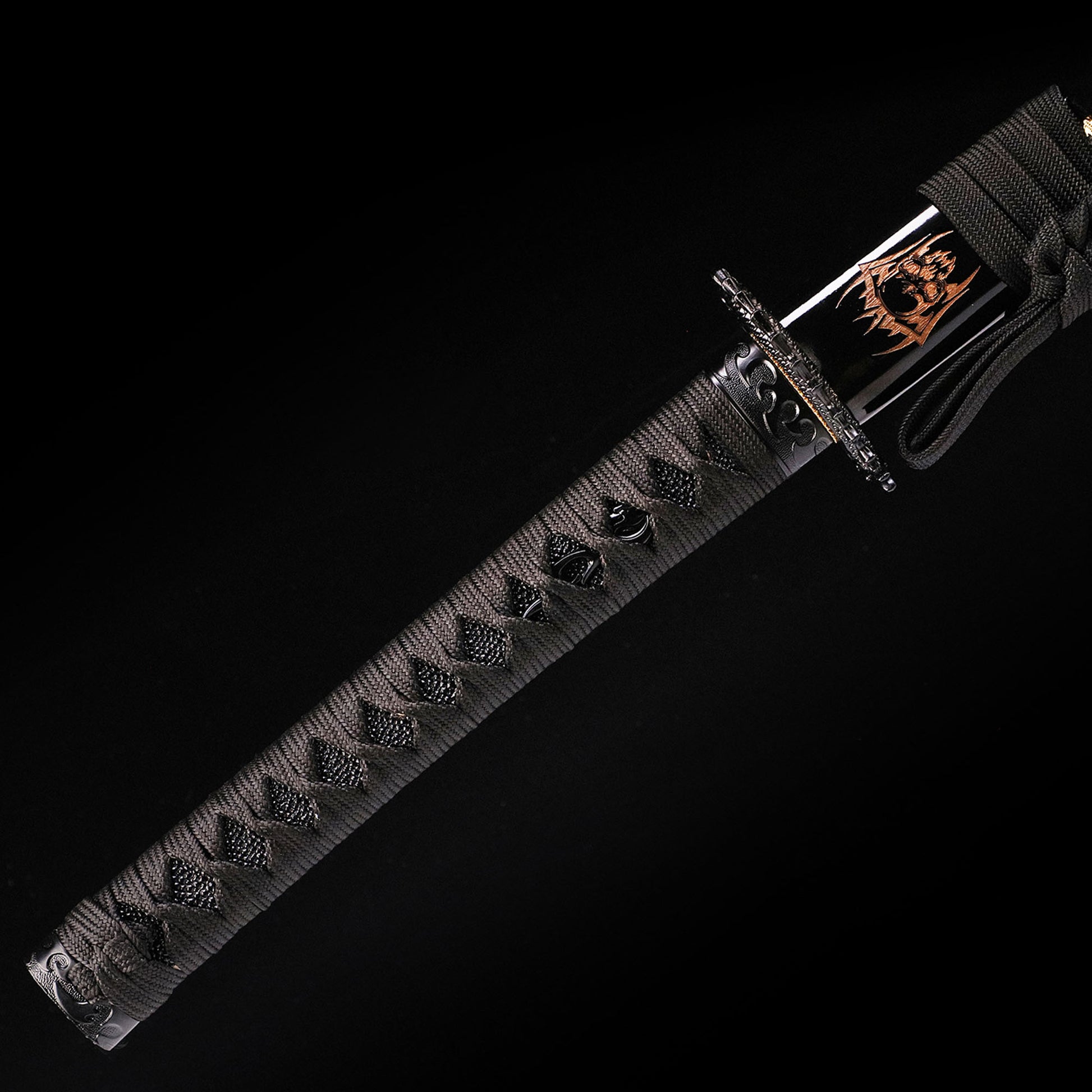 Black Dragon katana handle close-up - black tsuka wrap with dragon design