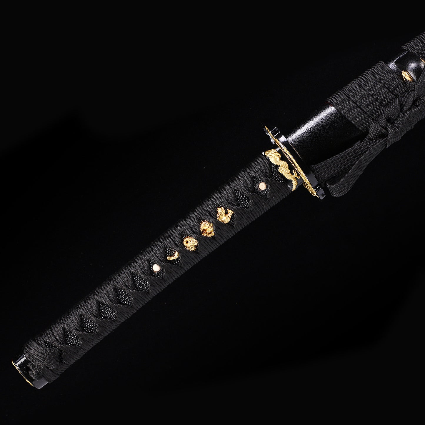 Black Dragon katana handle close-up - black tsuka wrap with dragon design