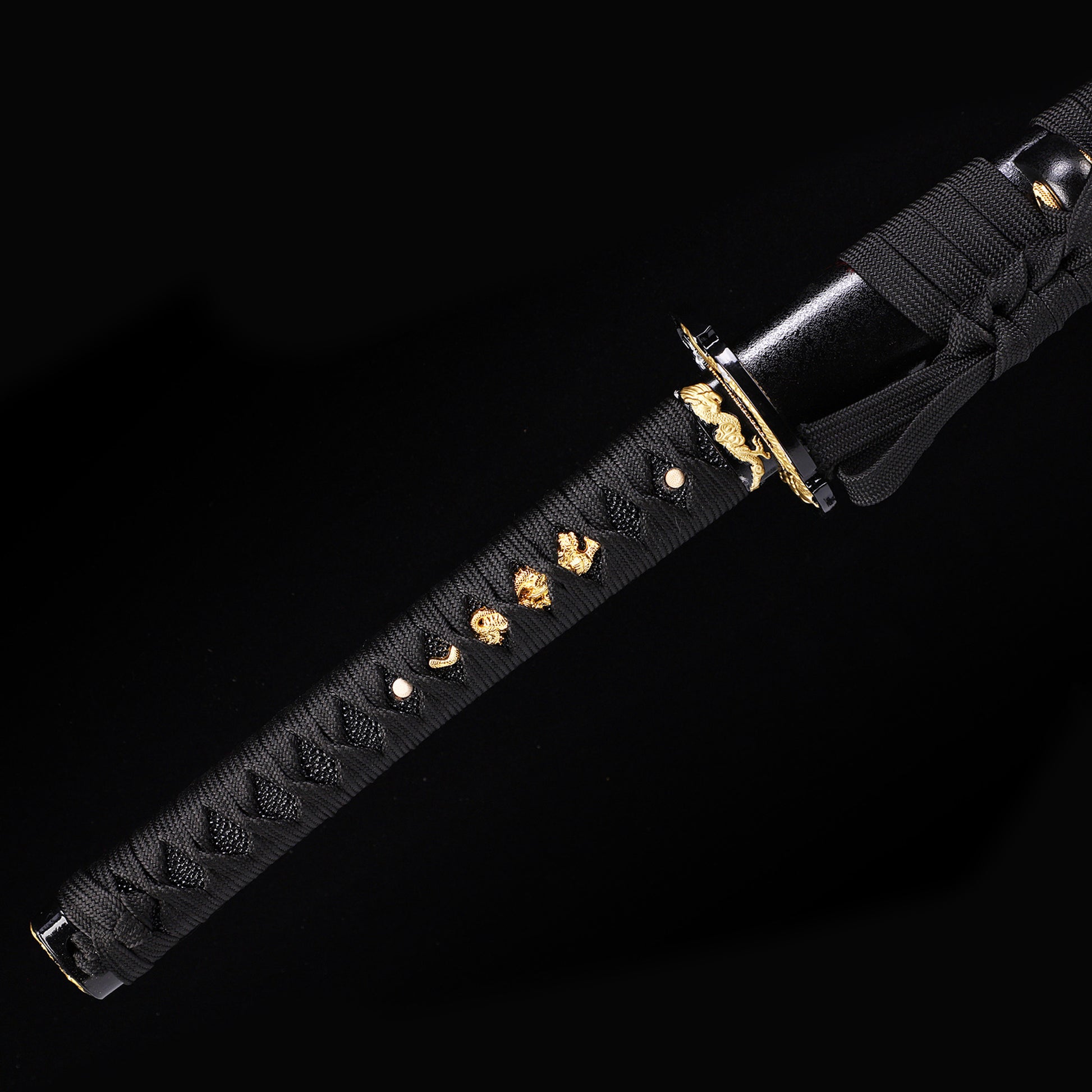 Black Dragon katana handle close-up - black tsuka wrap with dragon design