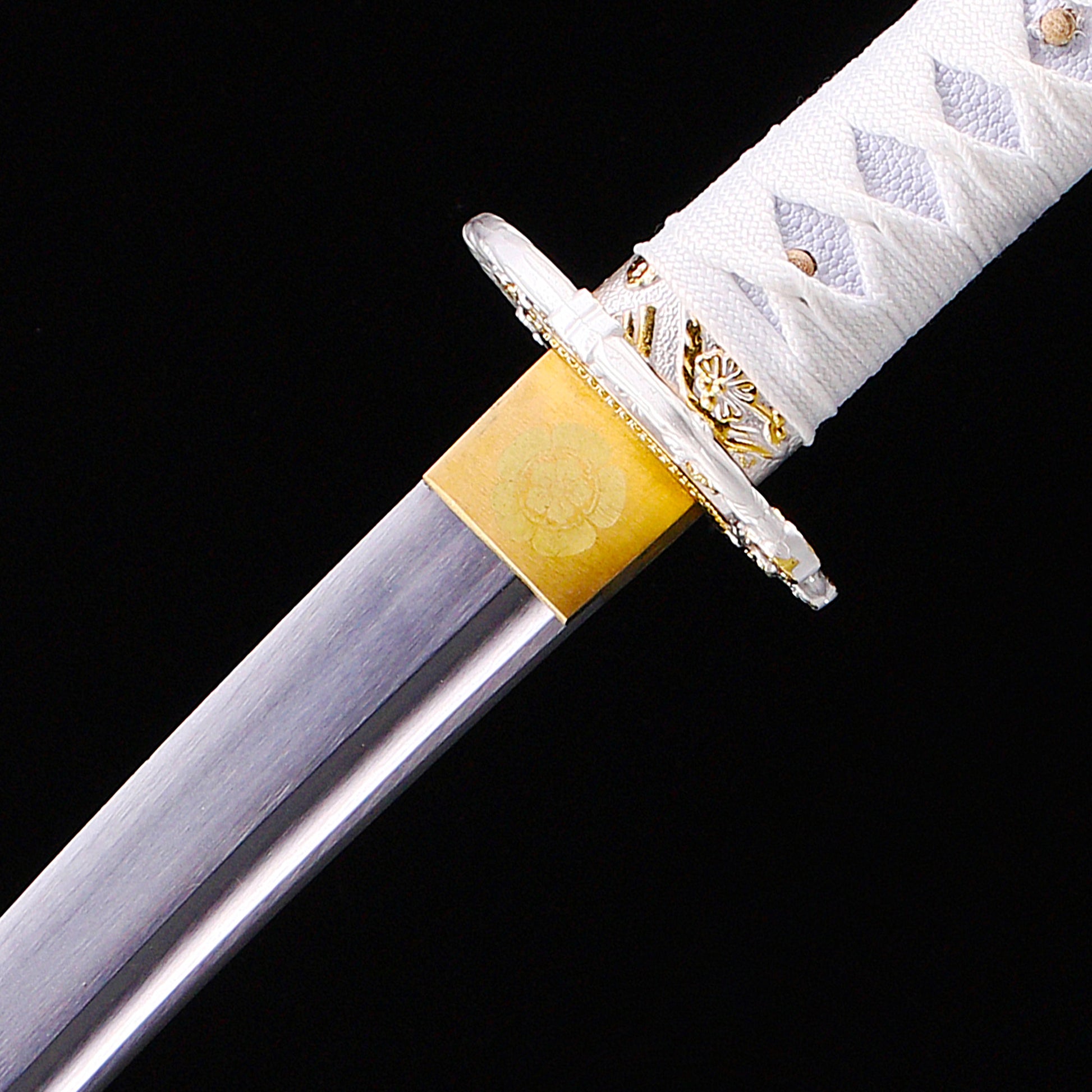 White handle floral tanto blade close-up - razor sharp steel edge and hamon detail